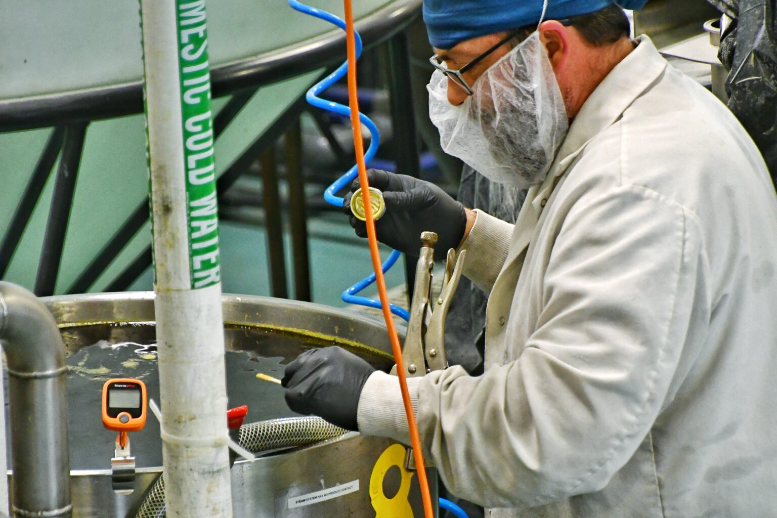 A Chaé technician working at a production tank