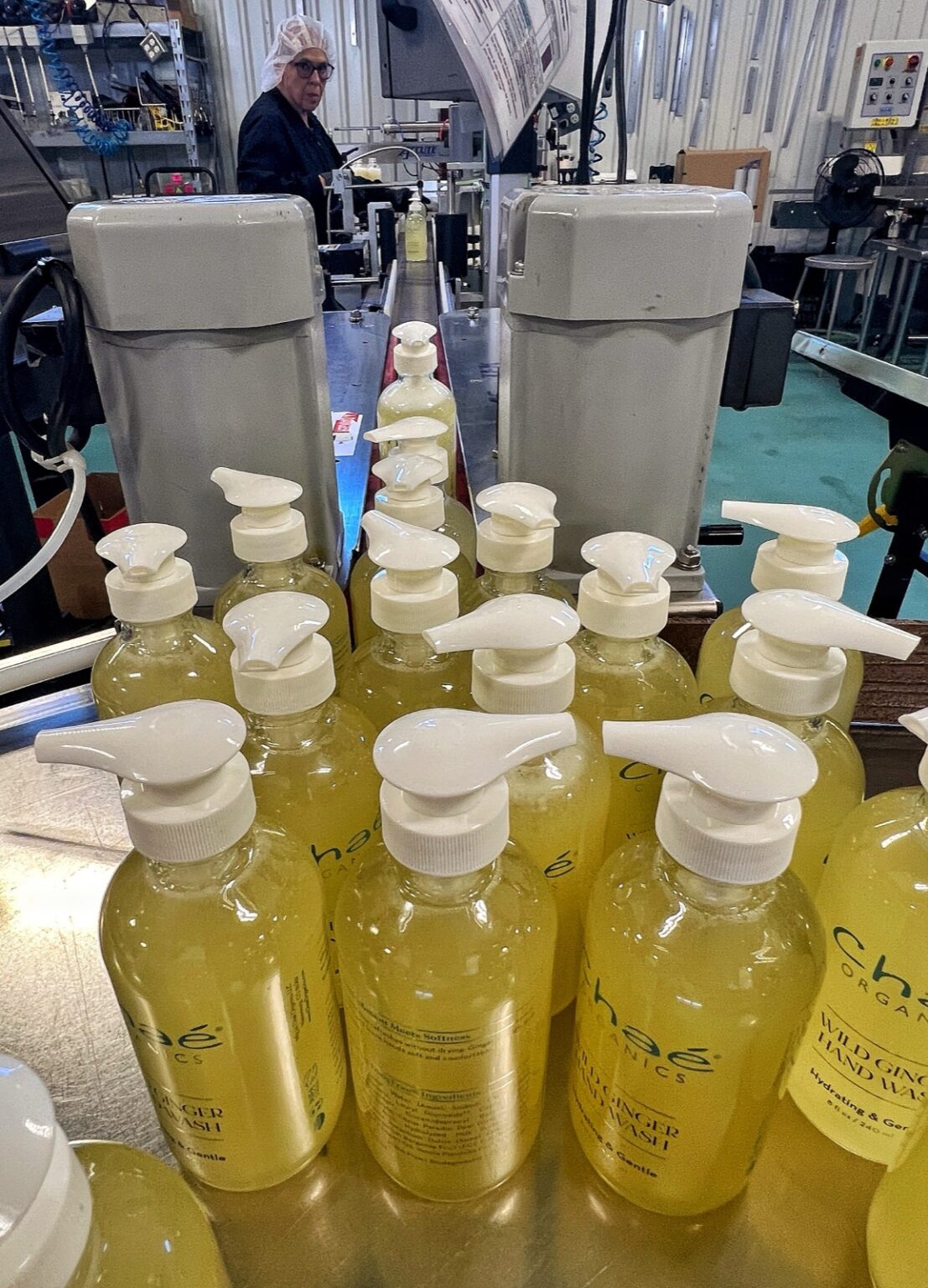 Rows of filled Chaé pump bottles coming off the production line