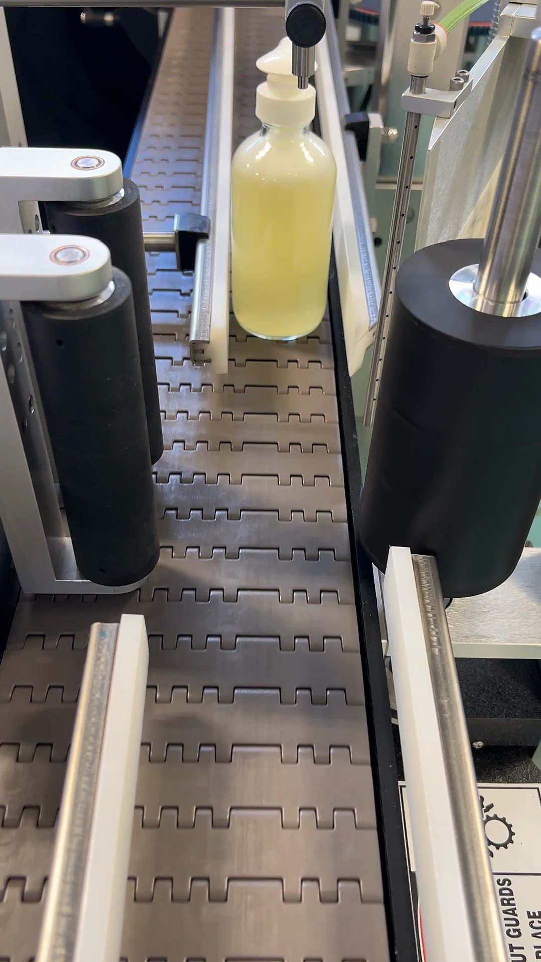 Pump bottle passing through the labeling machine at Chaé Manufacturing
